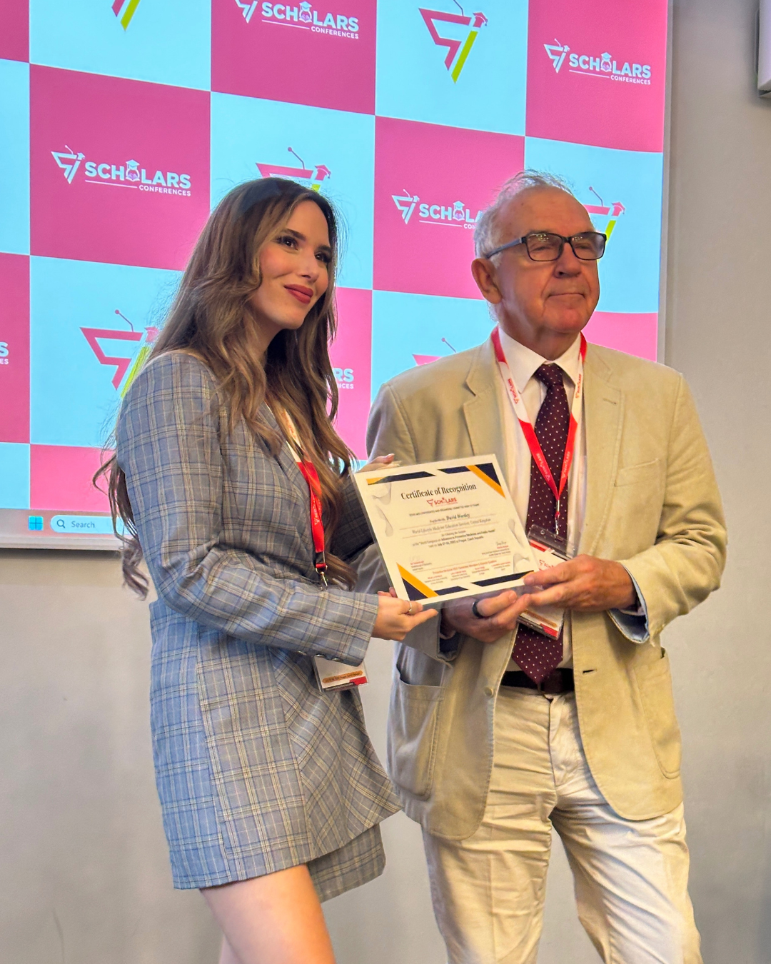 Aly Vredenburgh receiving certificate at Scholars Conference